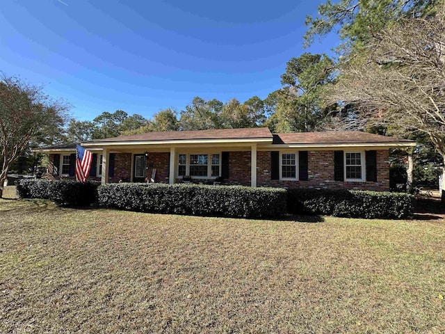 single story home with brick siding and a front lawn