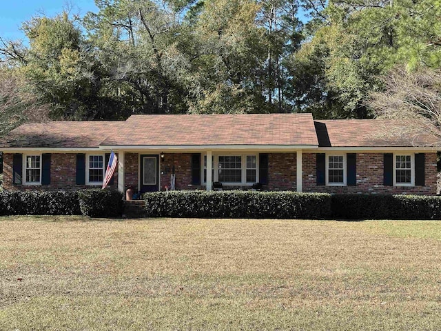 single story home with a front lawn and brick siding