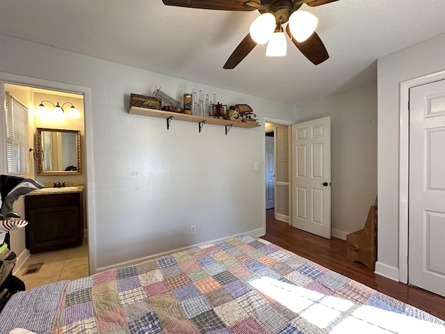 unfurnished bedroom featuring visible vents, baseboards, a ceiling fan, ensuite bath, and light wood-type flooring