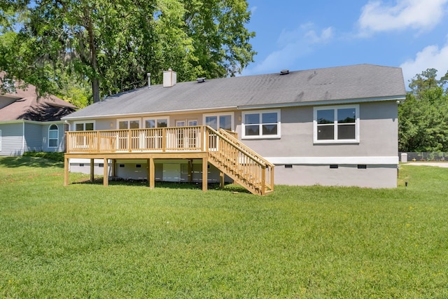 rear view of property with a wooden deck and a yard