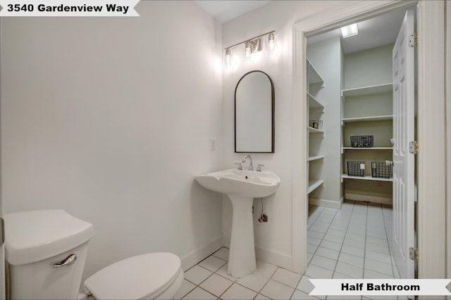 bathroom with toilet and tile patterned floors