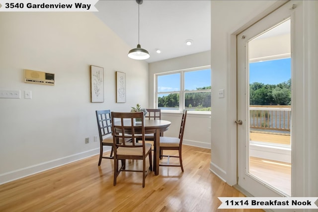 dining area with lofted ceiling and light hardwood / wood-style floors