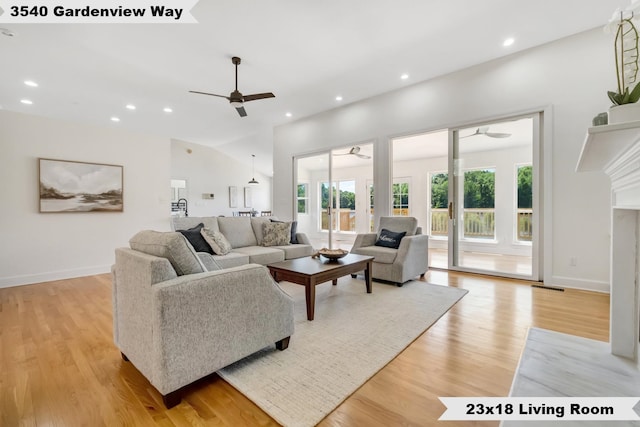 living room with a wealth of natural light, lofted ceiling, light hardwood / wood-style floors, and ceiling fan