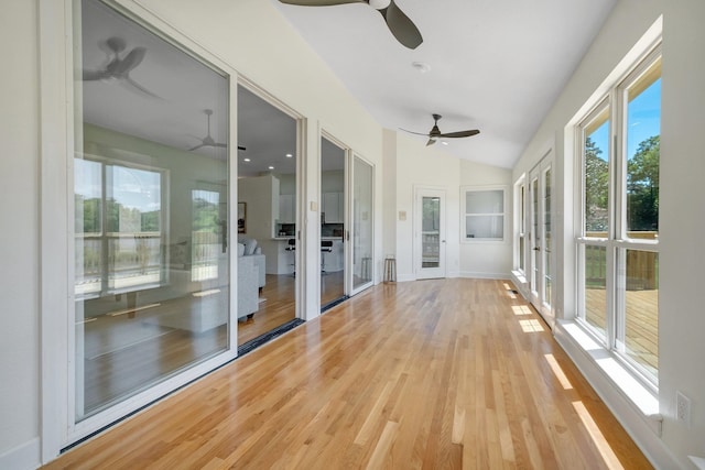 unfurnished sunroom featuring vaulted ceiling and french doors