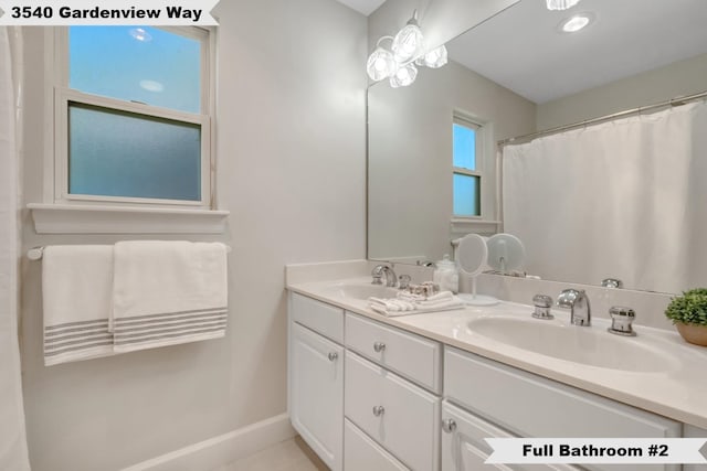 bathroom with vanity and curtained shower