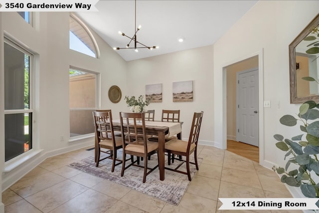 tiled dining room with high vaulted ceiling and a notable chandelier