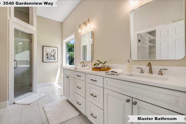 bathroom featuring tile patterned flooring, an enclosed shower, and vanity