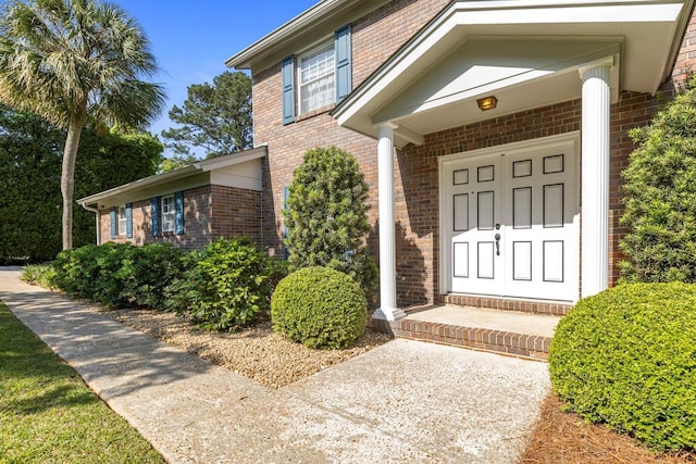 property entrance featuring brick siding