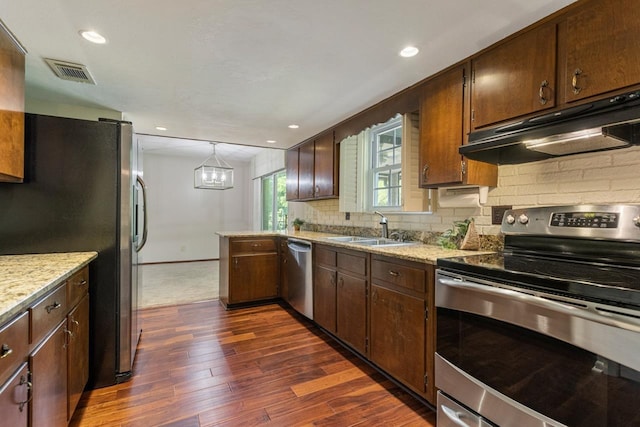 kitchen with backsplash, dark wood-style flooring, visible vents, appliances with stainless steel finishes, and under cabinet range hood