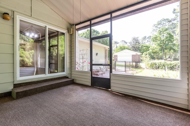 unfurnished sunroom featuring an inviting chandelier