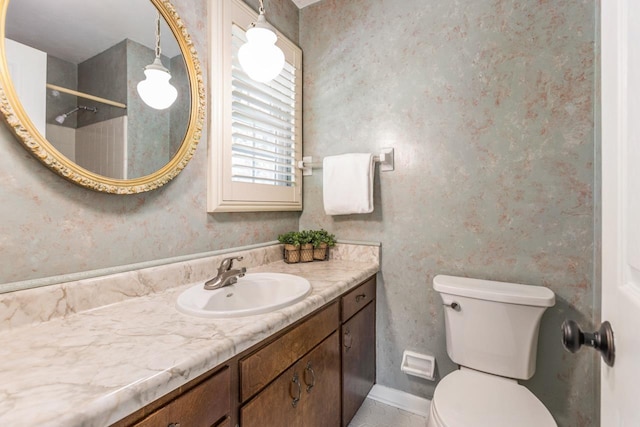 full bath featuring toilet, wallpapered walls, and vanity