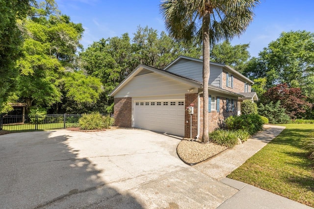 view of home's exterior featuring concrete driveway, brick siding, an attached garage, and fence