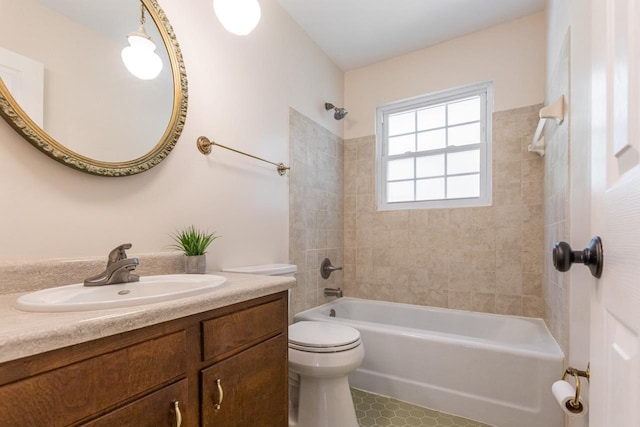 bathroom featuring toilet, tub / shower combination, and vanity