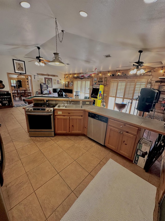 kitchen with light tile patterned floors, appliances with stainless steel finishes, ceiling fan, visible vents, and open floor plan