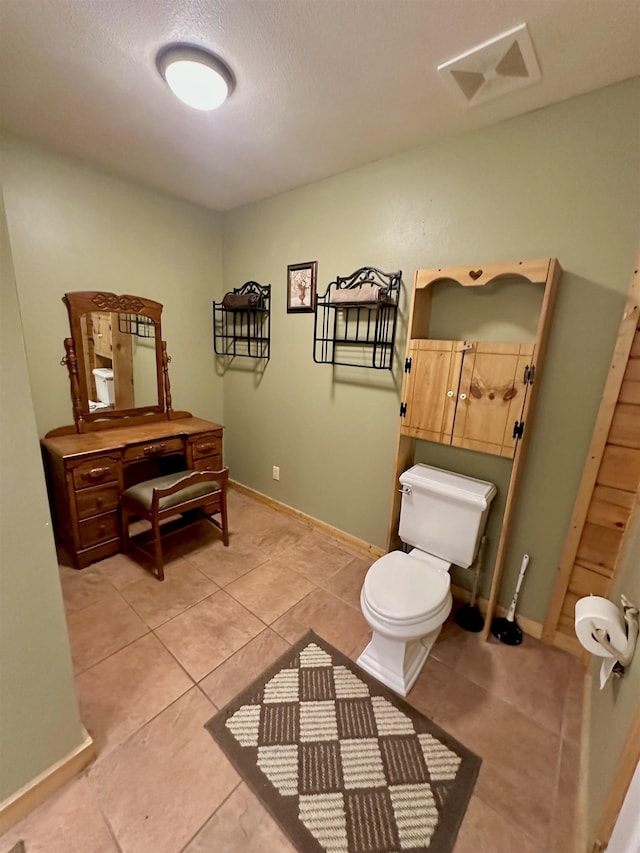 bathroom featuring visible vents, toilet, tile patterned flooring, and baseboards