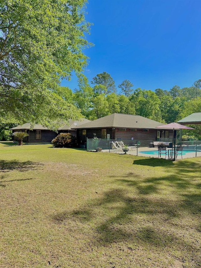 surrounding community featuring fence, a yard, and a swimming pool