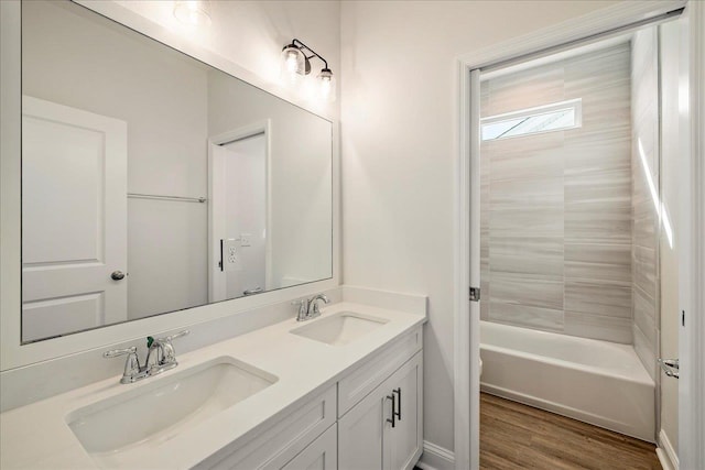 full bathroom with toilet, vanity, tiled shower / bath, and wood-type flooring