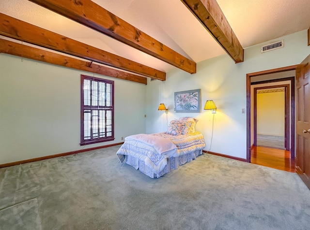 carpeted bedroom featuring beam ceiling