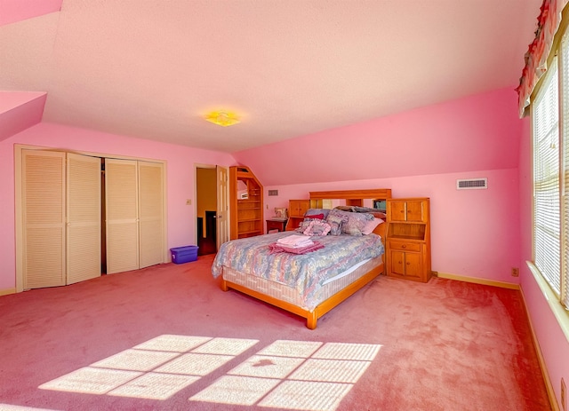 bedroom with carpet floors and vaulted ceiling