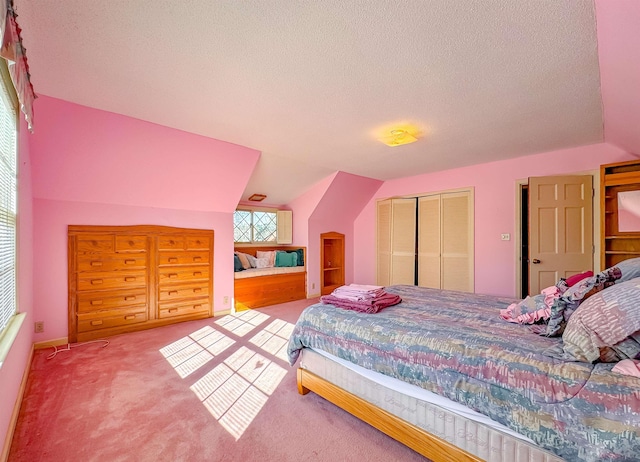 bedroom with carpet flooring, a textured ceiling, a closet, and lofted ceiling