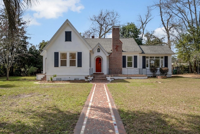 tudor-style house with a front lawn