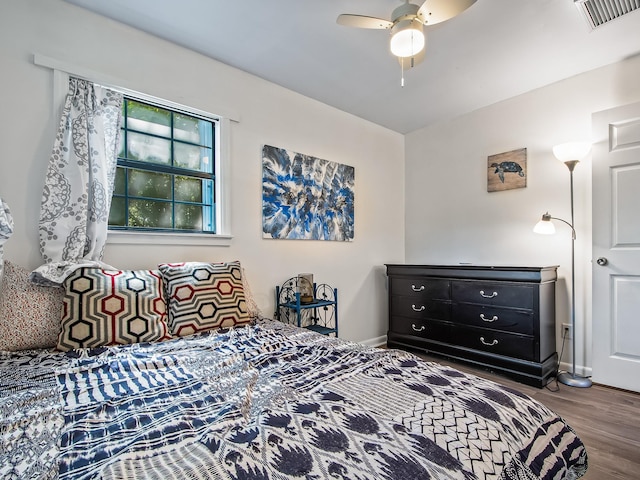 bedroom with ceiling fan and wood-type flooring