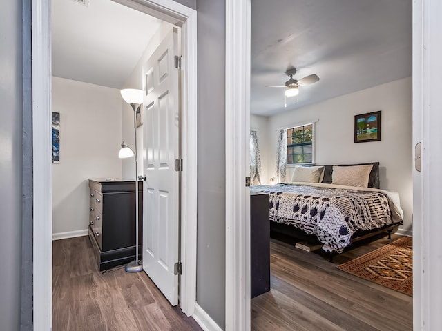 bedroom with ceiling fan and dark wood-type flooring