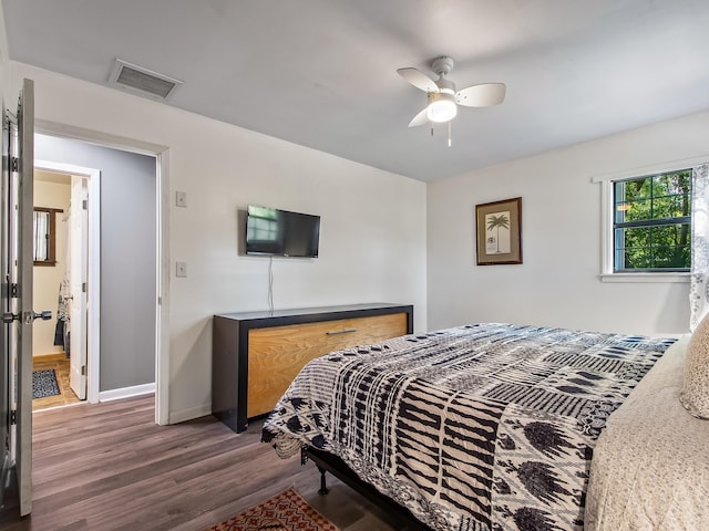 bedroom with ceiling fan and dark hardwood / wood-style floors