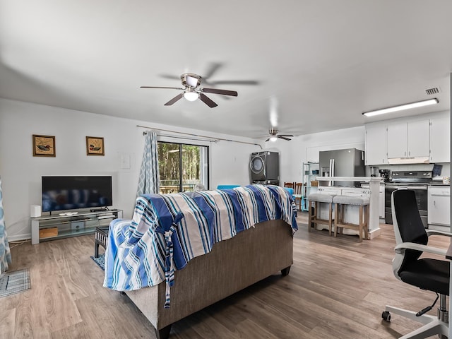 living room featuring ceiling fan and light hardwood / wood-style flooring