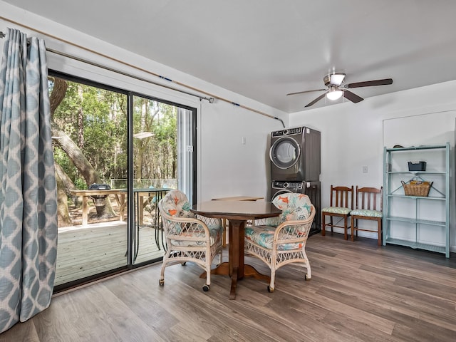 dining area with stacked washer / dryer, ceiling fan, and hardwood / wood-style floors