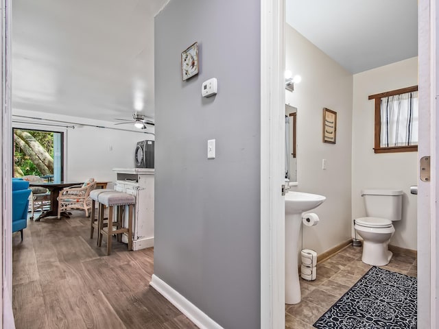 bathroom featuring ceiling fan, wood-type flooring, and toilet