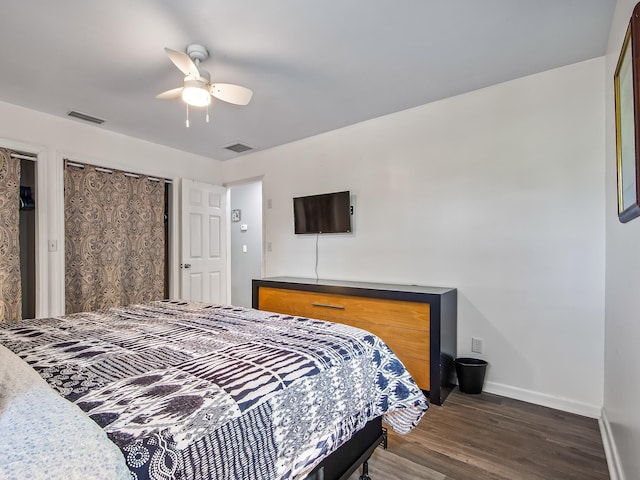 bedroom with ceiling fan and dark hardwood / wood-style floors