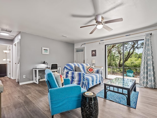 living room with hardwood / wood-style flooring and ceiling fan