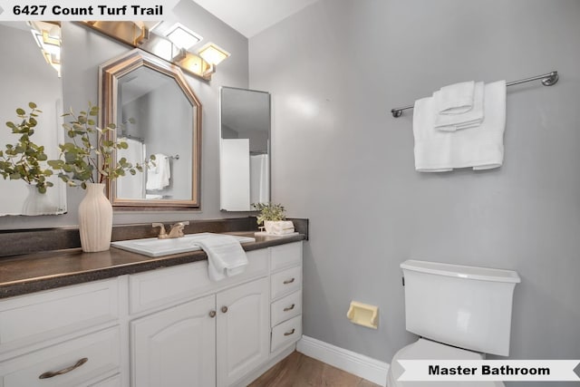 6427 Count Turf Trl, Tallahassee, FL 32309 - bathroom with vanity, toilet, and baseboards