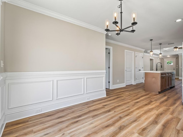 100 Kiowa Trl, Crawfordville, FL 32327 - kitchen featuring light countertops, a center island with sink, hanging light fixtures, and a sink