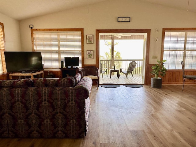 1268 Alligator Dr, Alligator Point, FL 32346 - living room with vaulted ceiling, wood finished floors, and a wainscoted wall