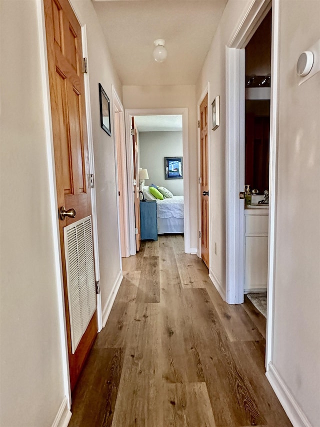 1268 Alligator Dr, Alligator Point, FL 32346 - corridor with wood finished floors and baseboards