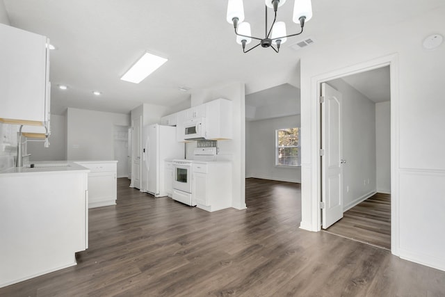 kitchen with sink, decorative light fixtures, white cabinets, white appliances, and dark wood-type flooring