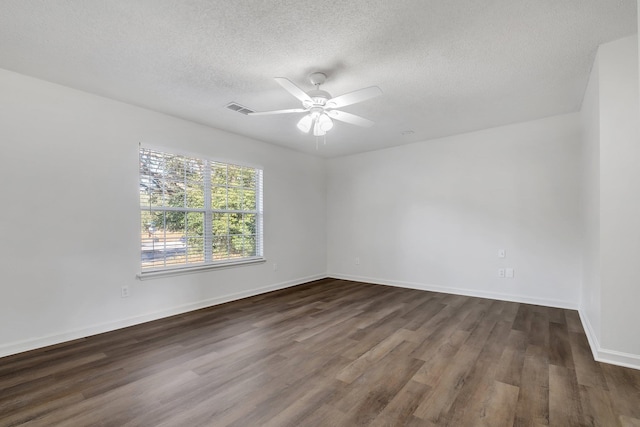 spare room featuring ceiling fan, dark hardwood / wood-style flooring, and a textured ceiling