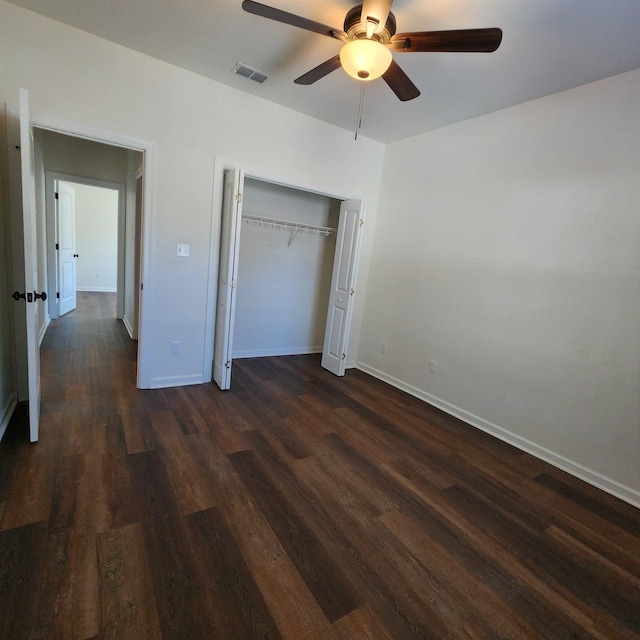 unfurnished bedroom featuring dark hardwood / wood-style flooring, a closet, and ceiling fan