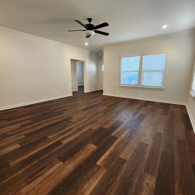 empty room with dark hardwood / wood-style floors, ceiling fan, and crown molding