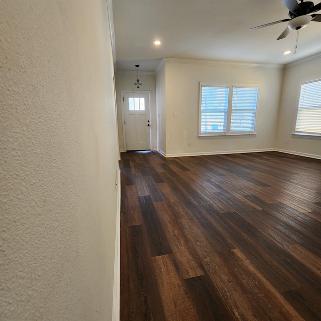 entrance foyer with dark hardwood / wood-style floors, ceiling fan, and crown molding