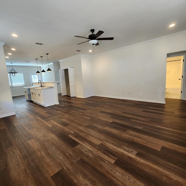 unfurnished living room with dark hardwood / wood-style floors, sink, and crown molding