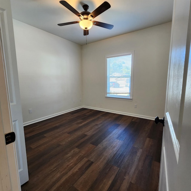 spare room featuring ceiling fan and dark wood-type flooring