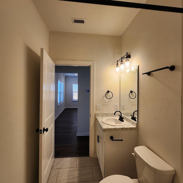 bathroom featuring tile patterned floors, vanity, and toilet