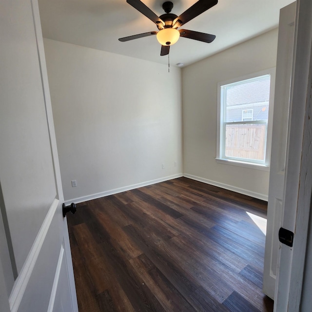 unfurnished room with ceiling fan and dark wood-type flooring