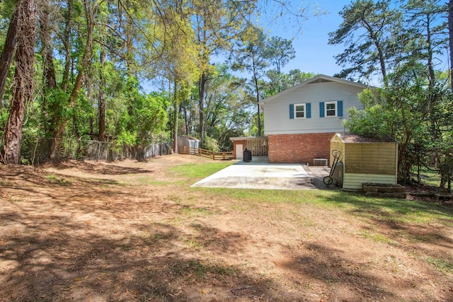 view of yard featuring fence and a patio area