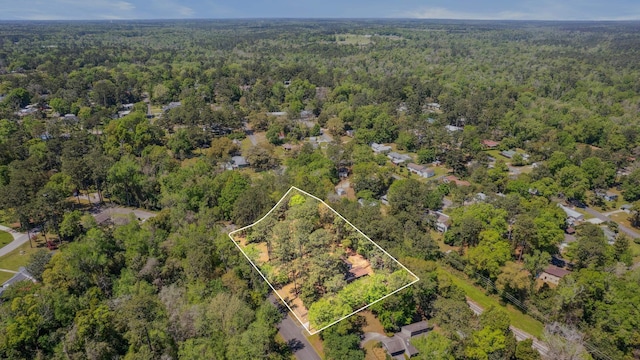 drone / aerial view featuring a forest view