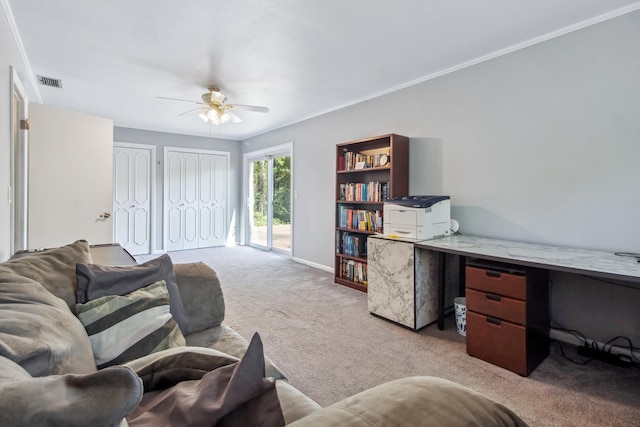 carpeted living room with a ceiling fan, crown molding, baseboards, and visible vents