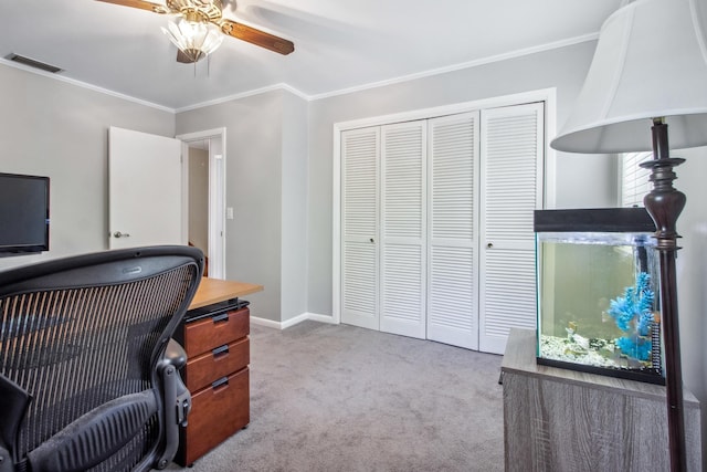 office space featuring ornamental molding, baseboards, carpet floors, visible vents, and a ceiling fan